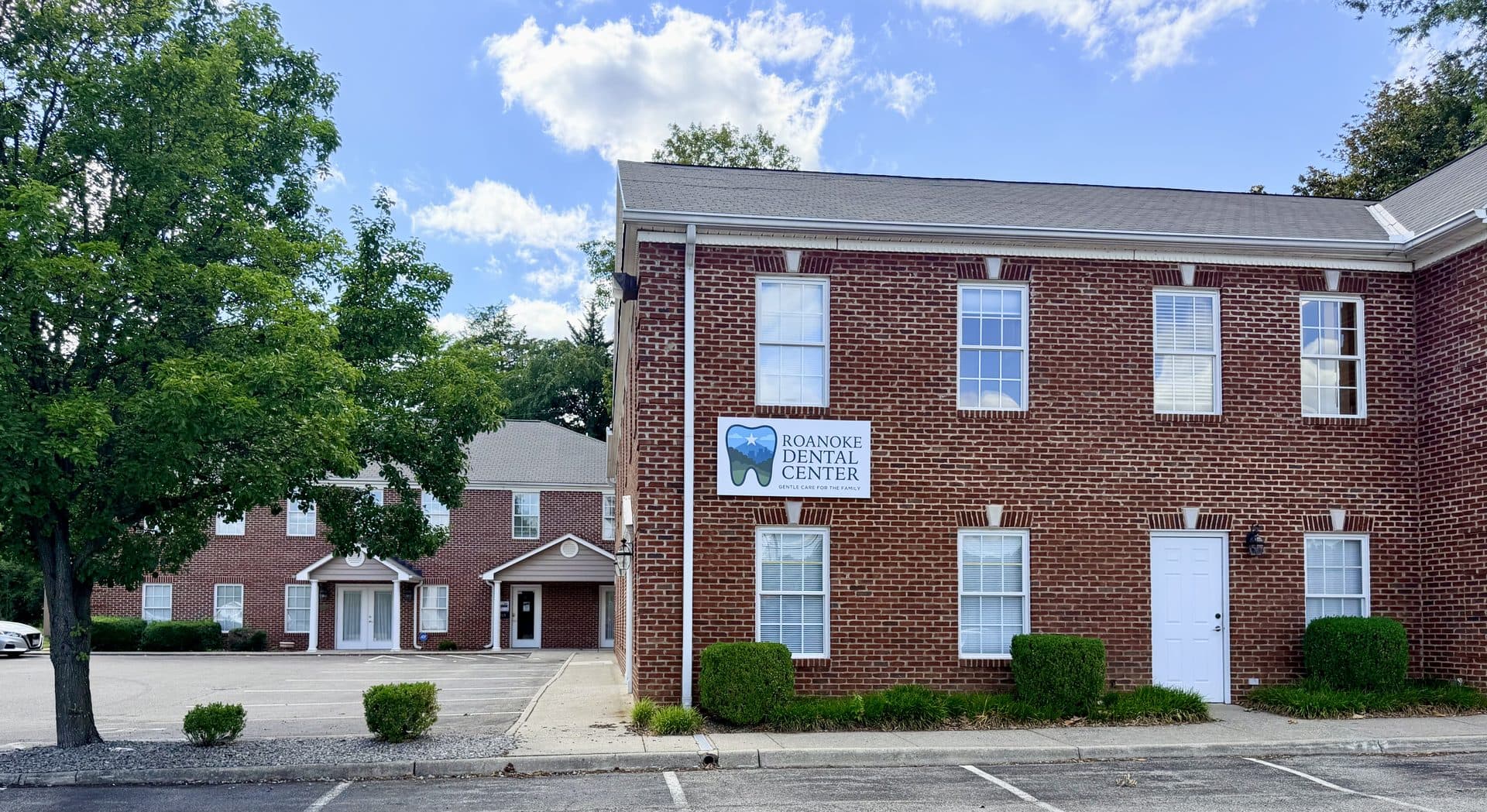 Roanoke Dental Center Brambleton Ave office in Cave Spring, a two-story brick building with on-site parking