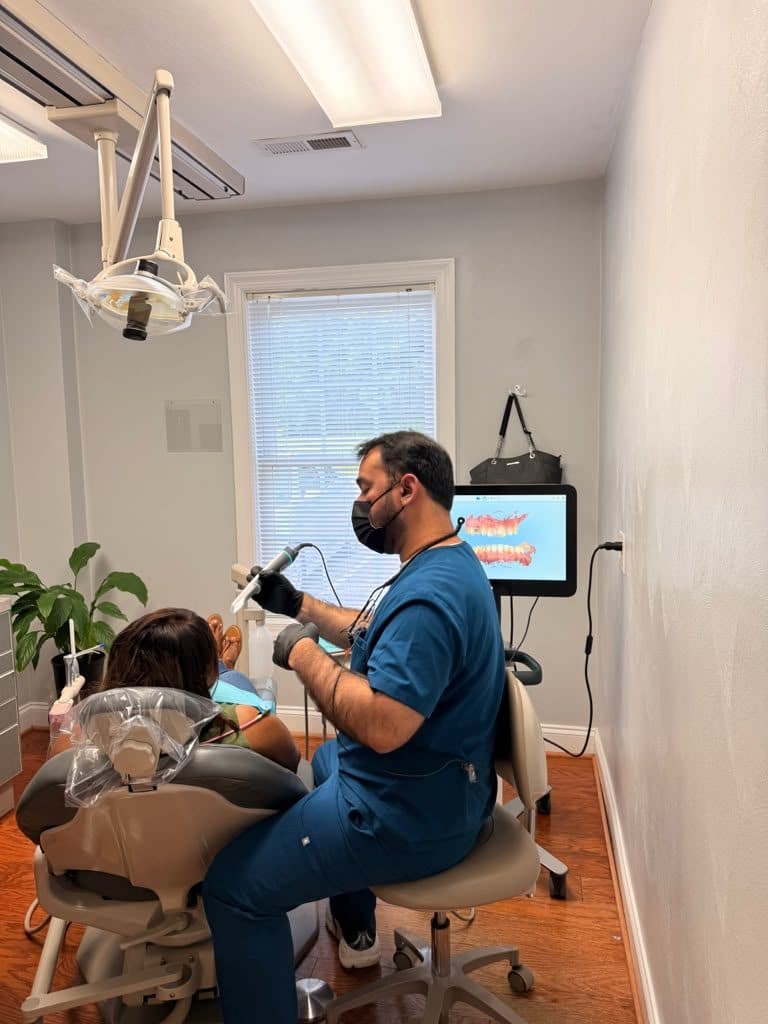 Dr. Razi taking a digital intraoral scan in a treatment room at the Roanoke Dental Center Brambleton Ave office in Cave Spring