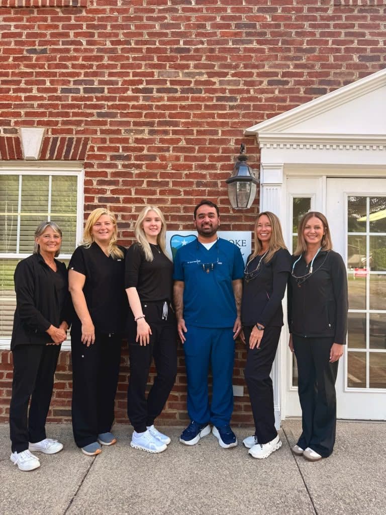 Dr. Razi's team at the Brambleton Ave front door of Roanoke Dental Center in Cave Spring