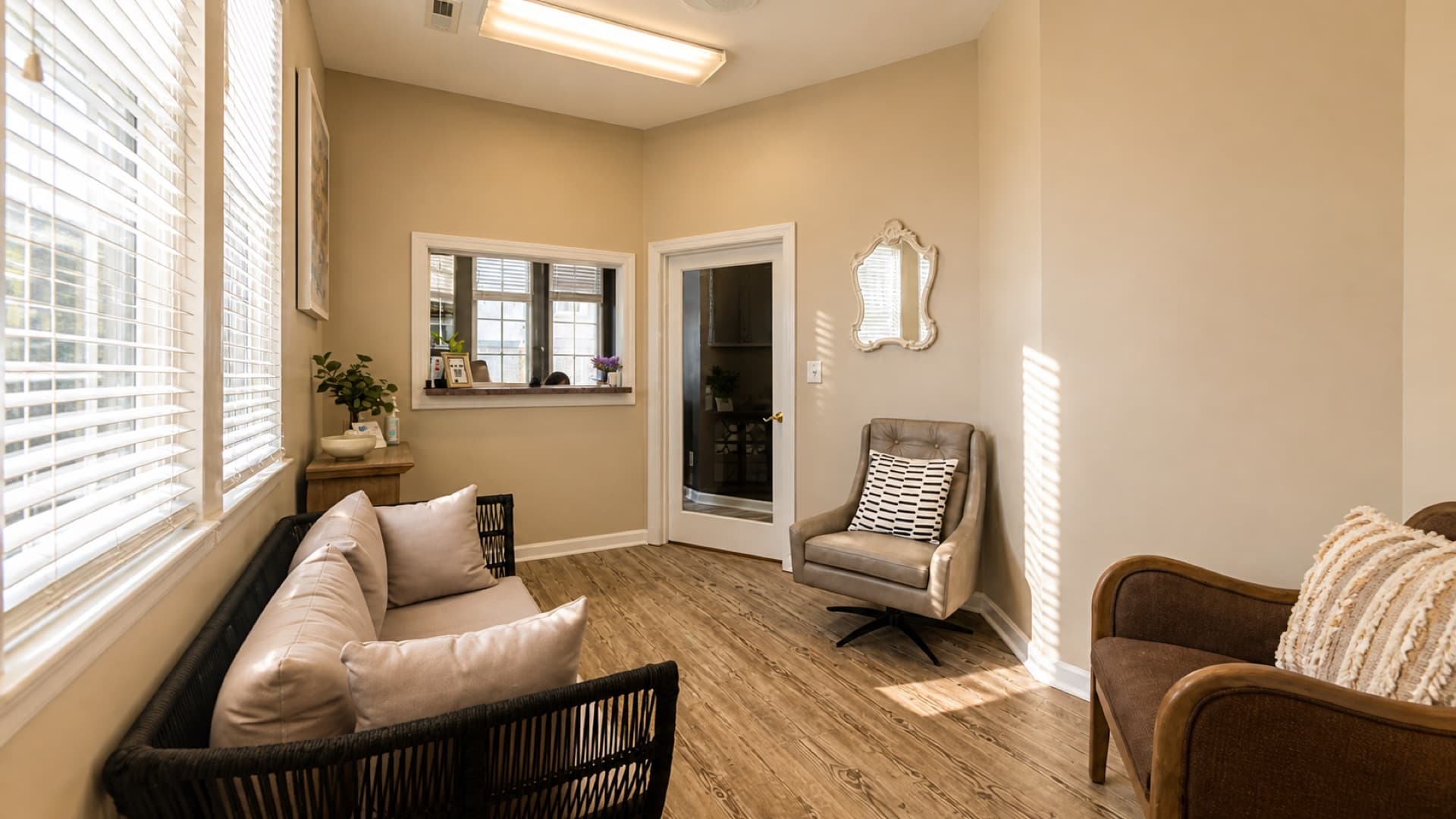 Invisalign consultation corner at Roanoke Dental Center with a warm wood console, greenery, and patient referral cards