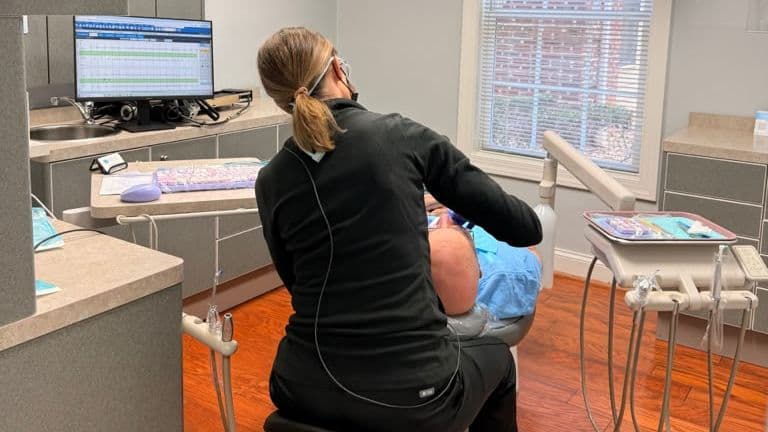 A Roanoke Dental Center hygienist working chairside during a cleaning visit