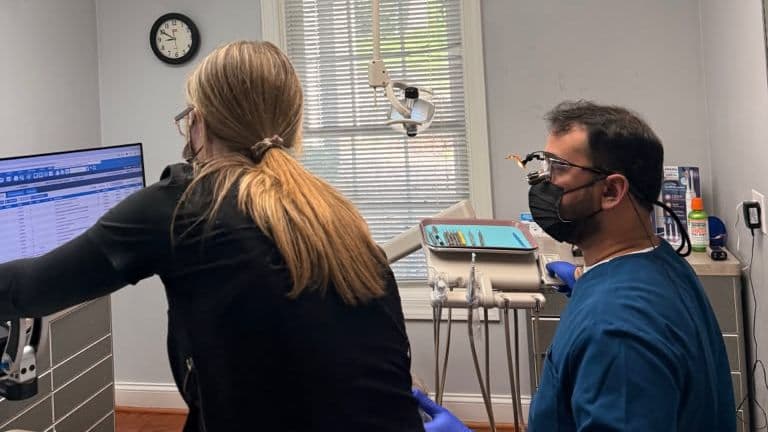 Roanoke Dental Center clinicians reviewing findings on a monitor in the operatory